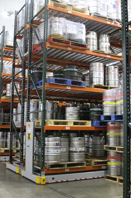 Beer kegs stored on a powered mobile pallet racking system