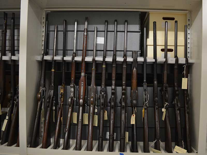 long gun weapon shelving with stock cup holders