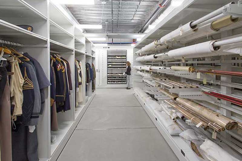 Museum with clothing storage and cantilever rolled textile rack