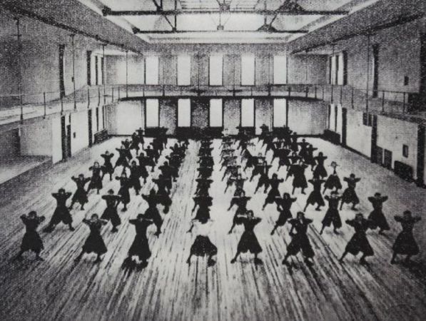 Old black and white image of people in the original gymnasium