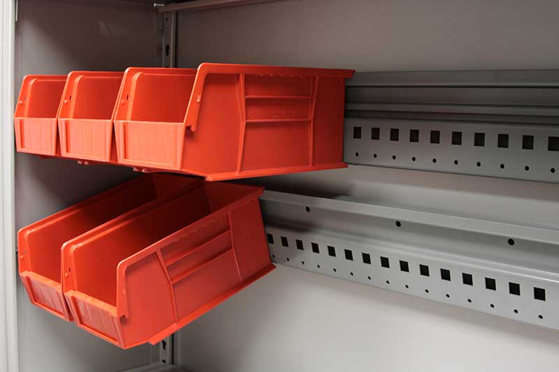 modular storage rail holding orange bins