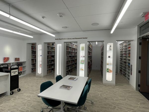 NMWA's reading room with Spacesaver stationary shelving holding books and some art displayed in glass cases on the ends