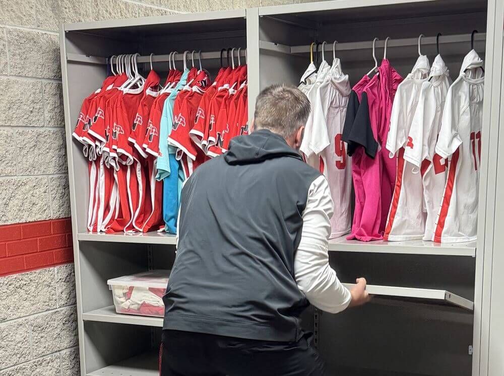 Northwestern College staff member adjusting the shelves on a Spacesaver 4-Post FreeSpan system