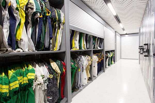 Oregon Ducks uniforms and jerserys in storage solution with tambour doors
