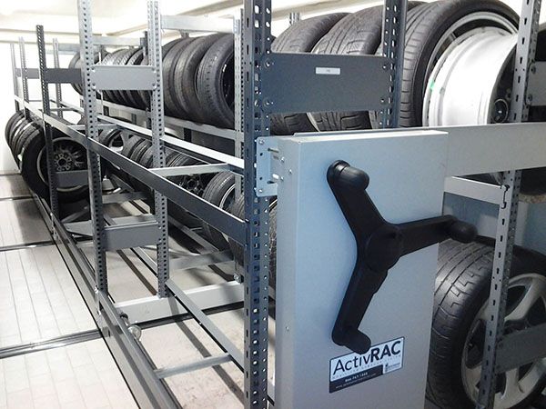 Mechanical assist mobile storage system holding car tires and wheels
