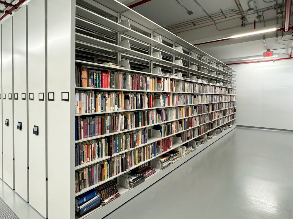 Rows of books stored on Spacesaver Powered High-Density Mobile Shelving systems in the Pritzker book storage wing