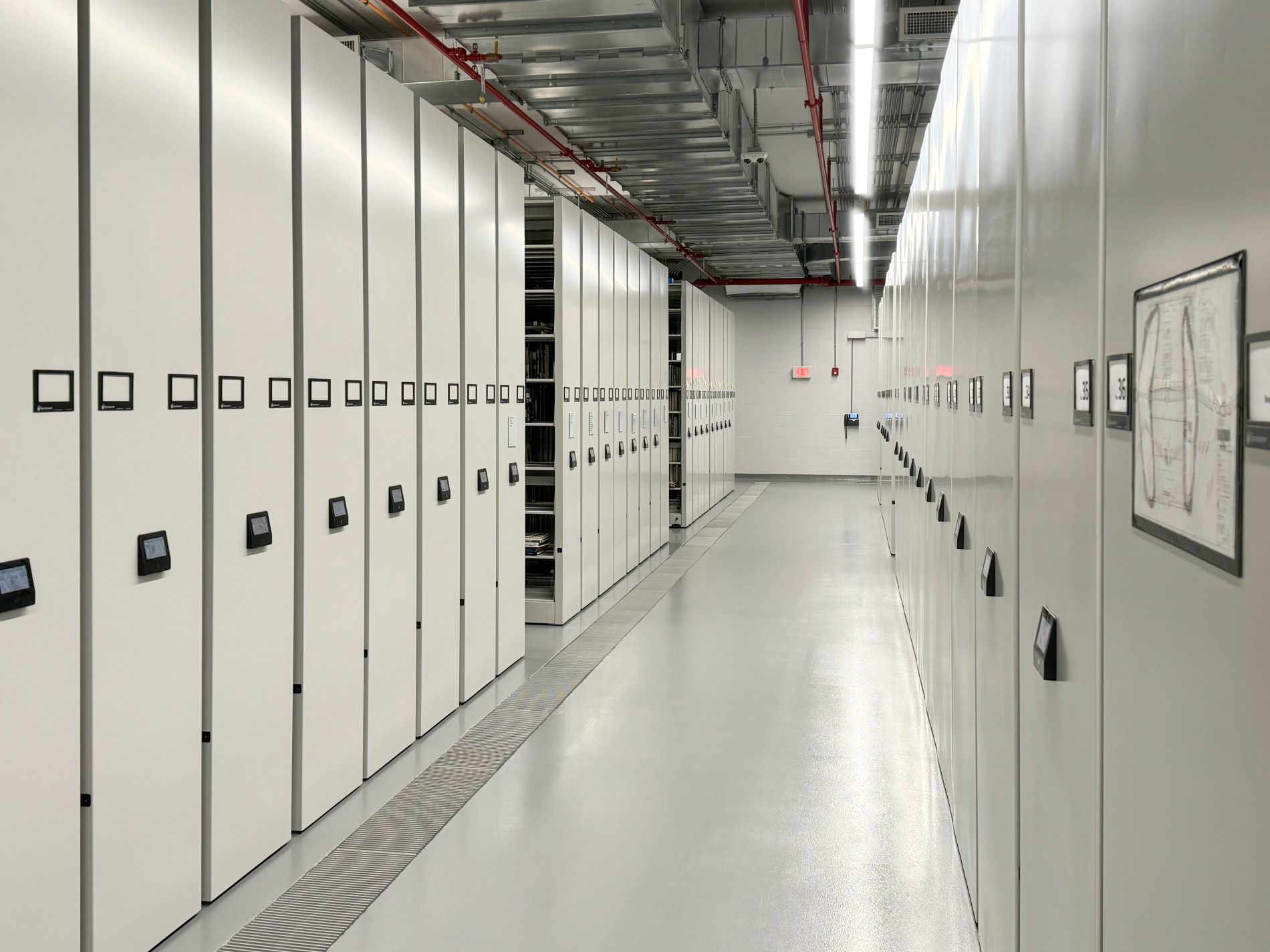 Hallway in between two Spacesaver Powered High-Density Mobile Storage systems