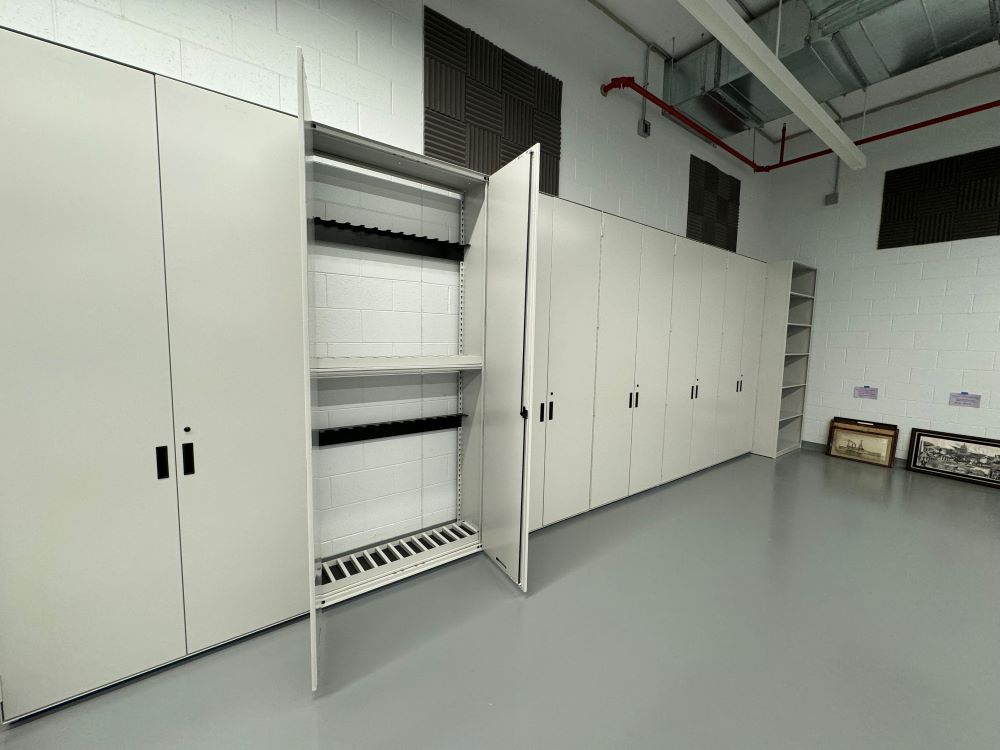 Multiple Spacesaver weapons storage cabinets with one's doors opened installed in Pritzker's weapons wing