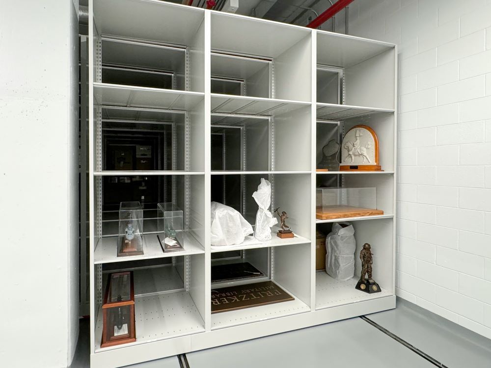 Various historical military artifacts stored on a Spacesaver High-Density Mobile Shelving system