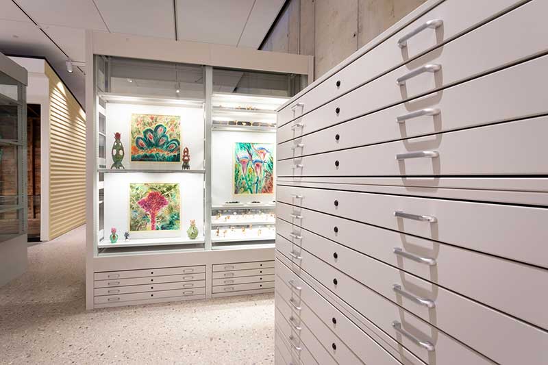 flat file cabinet with art in the background