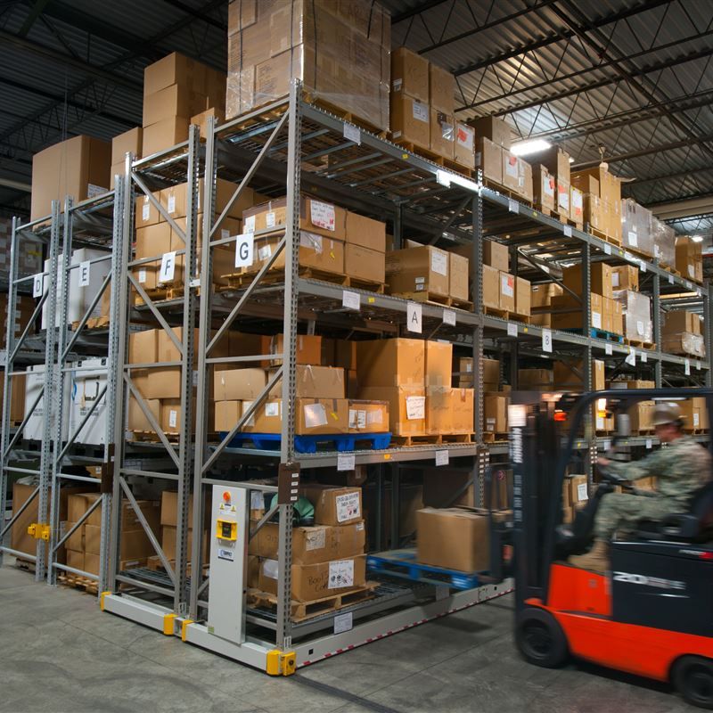 soldier on a forklift next to ActivRAC mobile shelving system in a warehouse