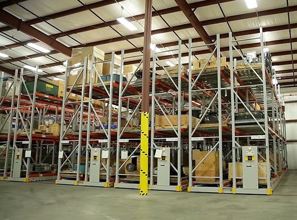 Powered mobile shelving system in a warehouse