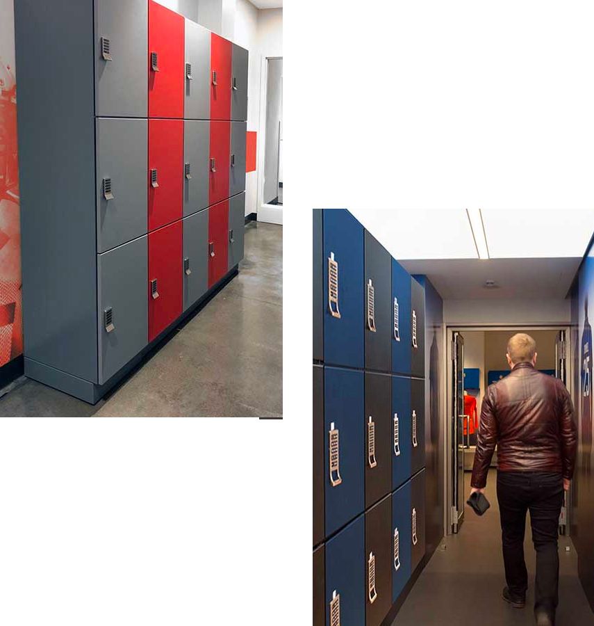 athletic facility day use lockers lining a wall with grey blue and red doors