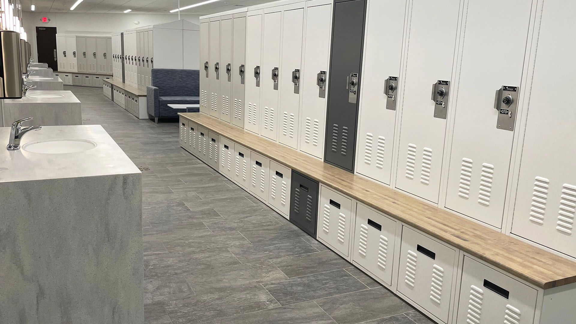 police locker room lockers and benches with multiple sinks across from them