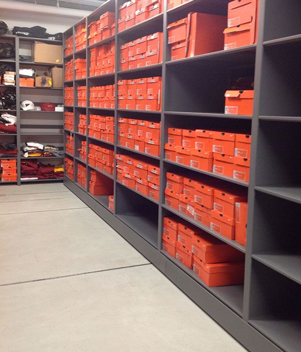 Boxes of shoes on Spacesaver storage system for college football