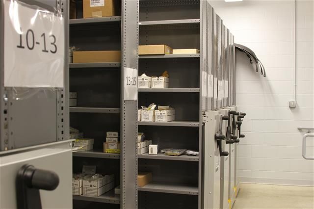 industrial parts and boxes stored on a mechanical assist mobile storage system