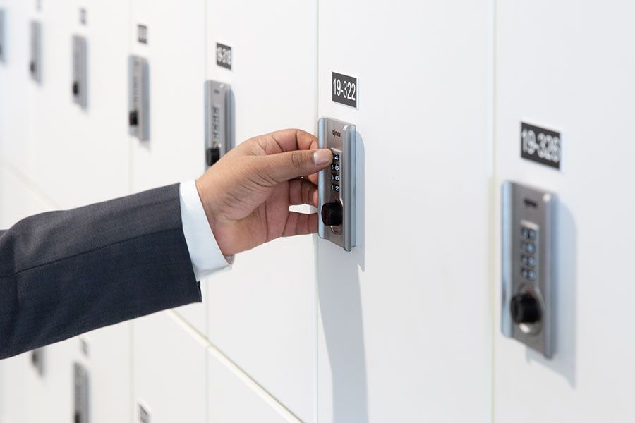 Persons hand pressing the keys on a day use locker's keypad