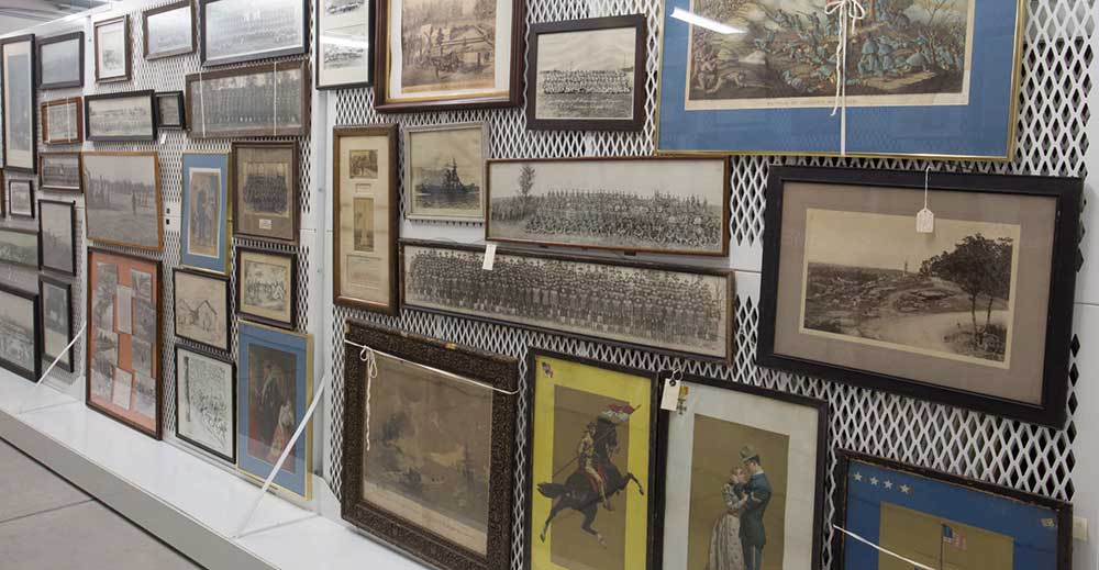 Framed paintings stored on mobile floor mounted art racks