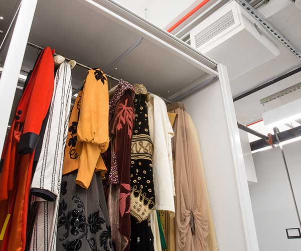 Hanging clothes in a high-density mobile storage system at fashion museum