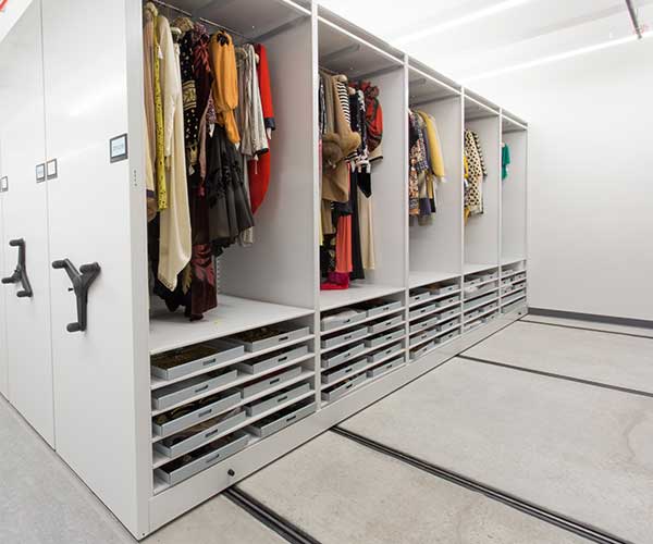 clothes stored on mechanical assist storage system at fashion museum