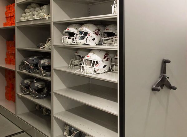 white football helmets and shoe boxes on Spacesaver mechanical assist system