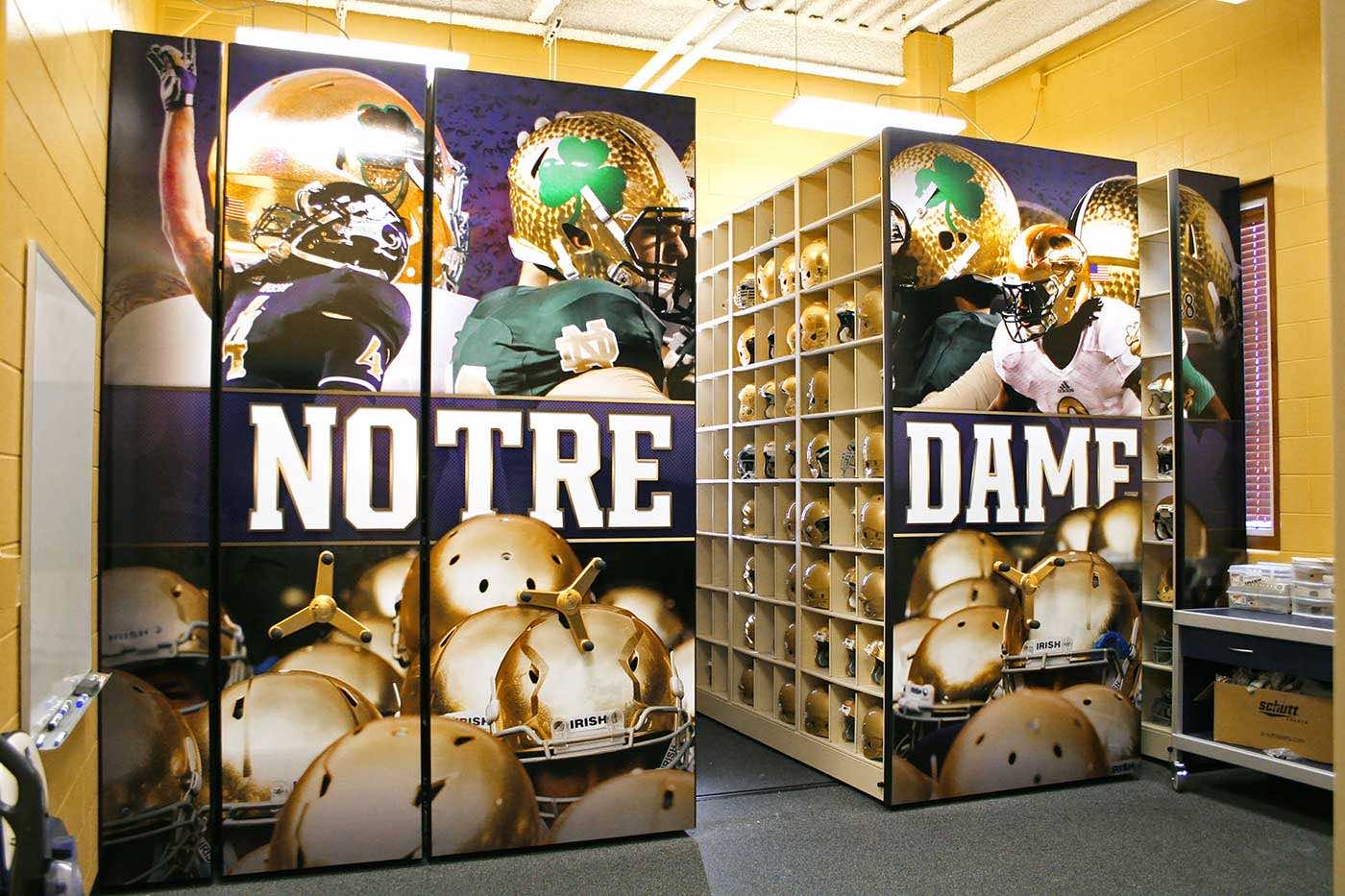 Notre Dame football helmets stored on high-density mobile storage system