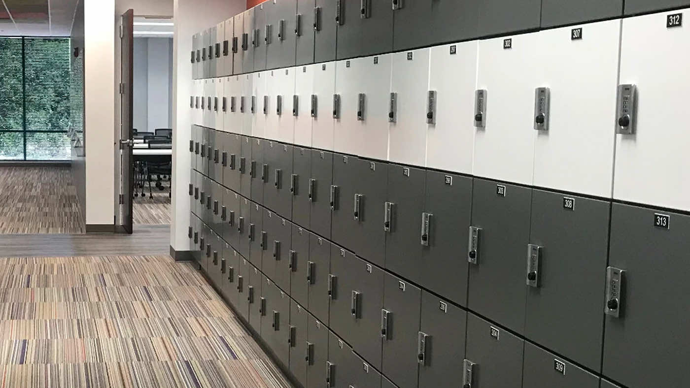 wall of high end gray and white personal storage lockers in office environment