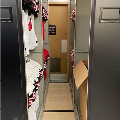red and white jerseys and boxes on Spacesaver high density mobile system