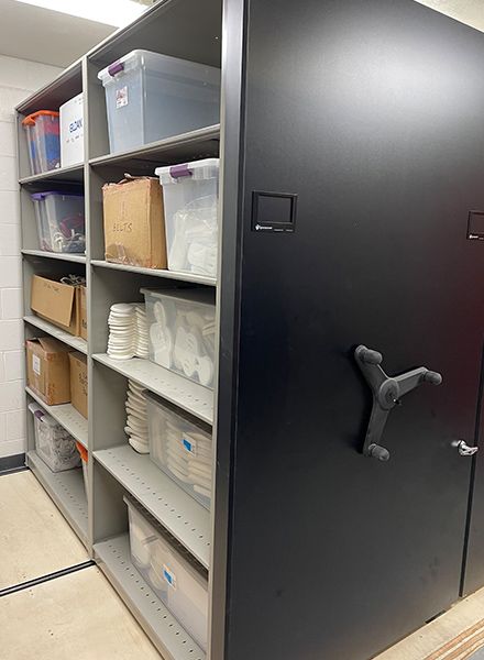 high school athletic equipment tubs on mobile shelving system