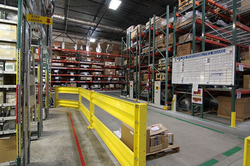 auto parts and boxes on a powered mobile racking system in a toyota warehouse