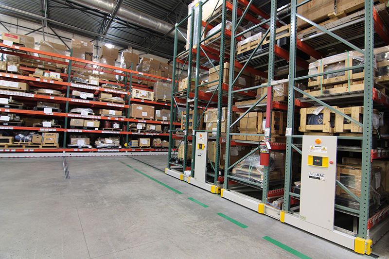 auto parts, boxes, and pallets on powered mobile racking systems in a toyota warehouse