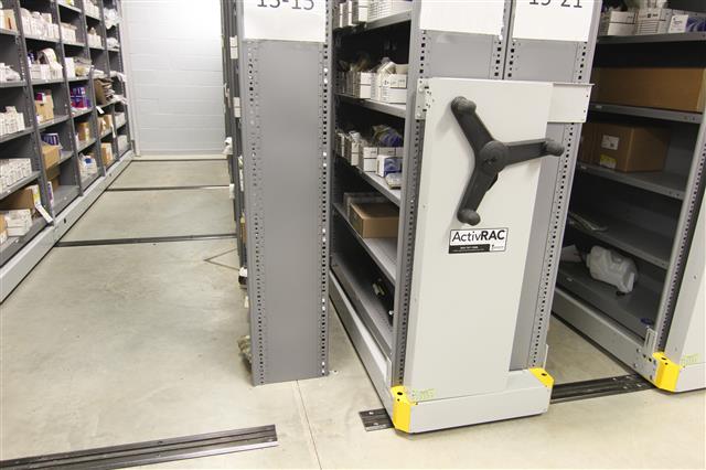 mechanical assist mobile shelving system with boxes and various parts