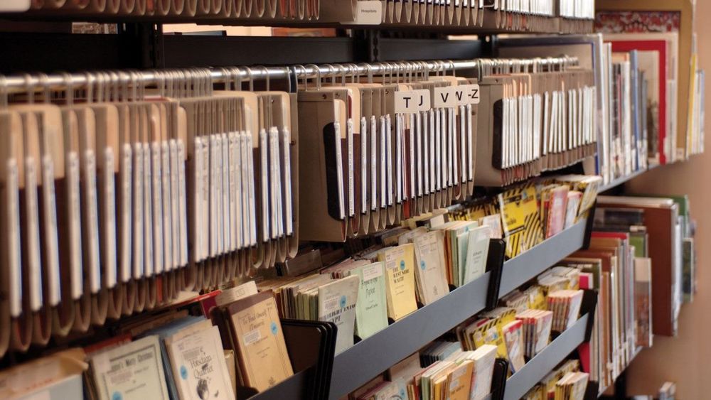 Sheet music hanging on a Spacesaver hanging storage system
