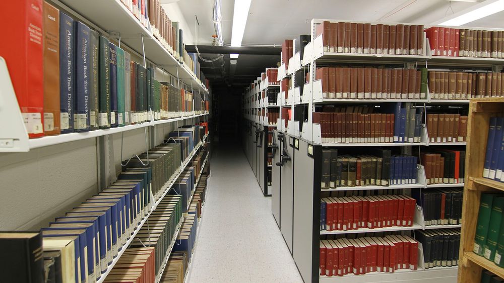 static shelving and high-density mobile shelving holding many books