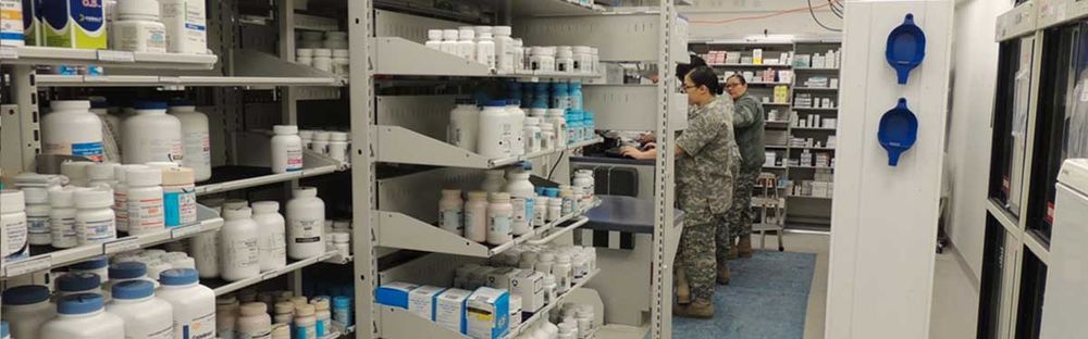 military pharmacy and staff utilizing spacesaver shelving for medicine storage