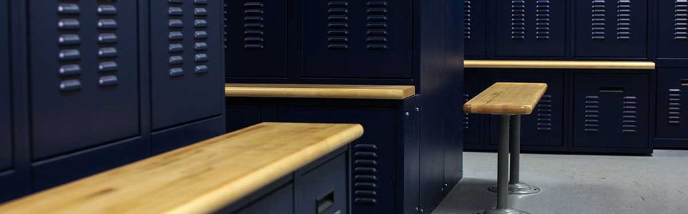 police locker room with blue storage lockers and wooden benches