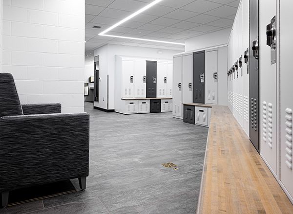 police locker room featuring black and gray lockers lining the walls