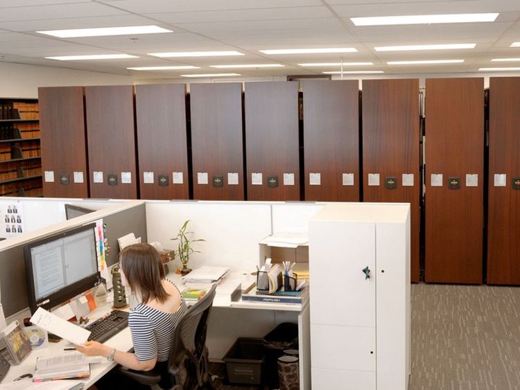 powered mobile shelving in law office behind a cubicle 