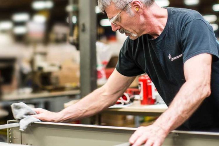 Spacesaver employee working on a metal solution