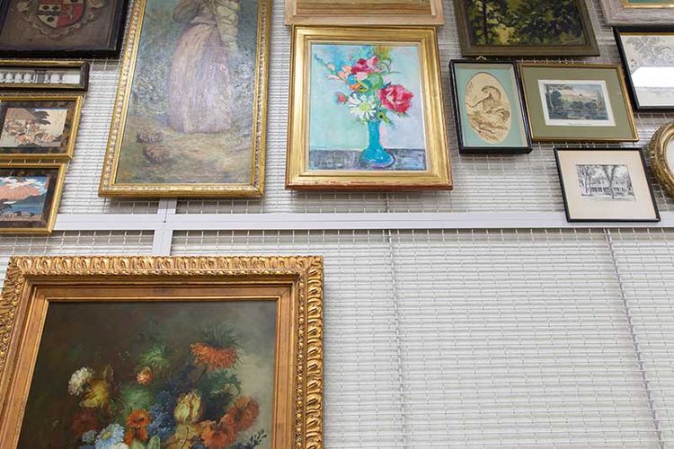 wall mounted art rack with art close up