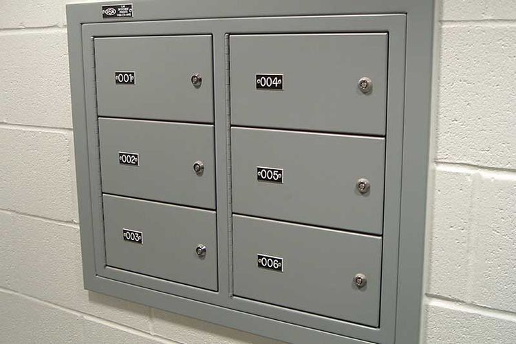 6 compartment wall-mounted gun locker mounted in concrete block wall