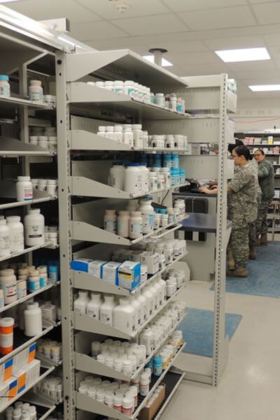 military pharmacy workers and supply storage on Spacesaver metal shelving