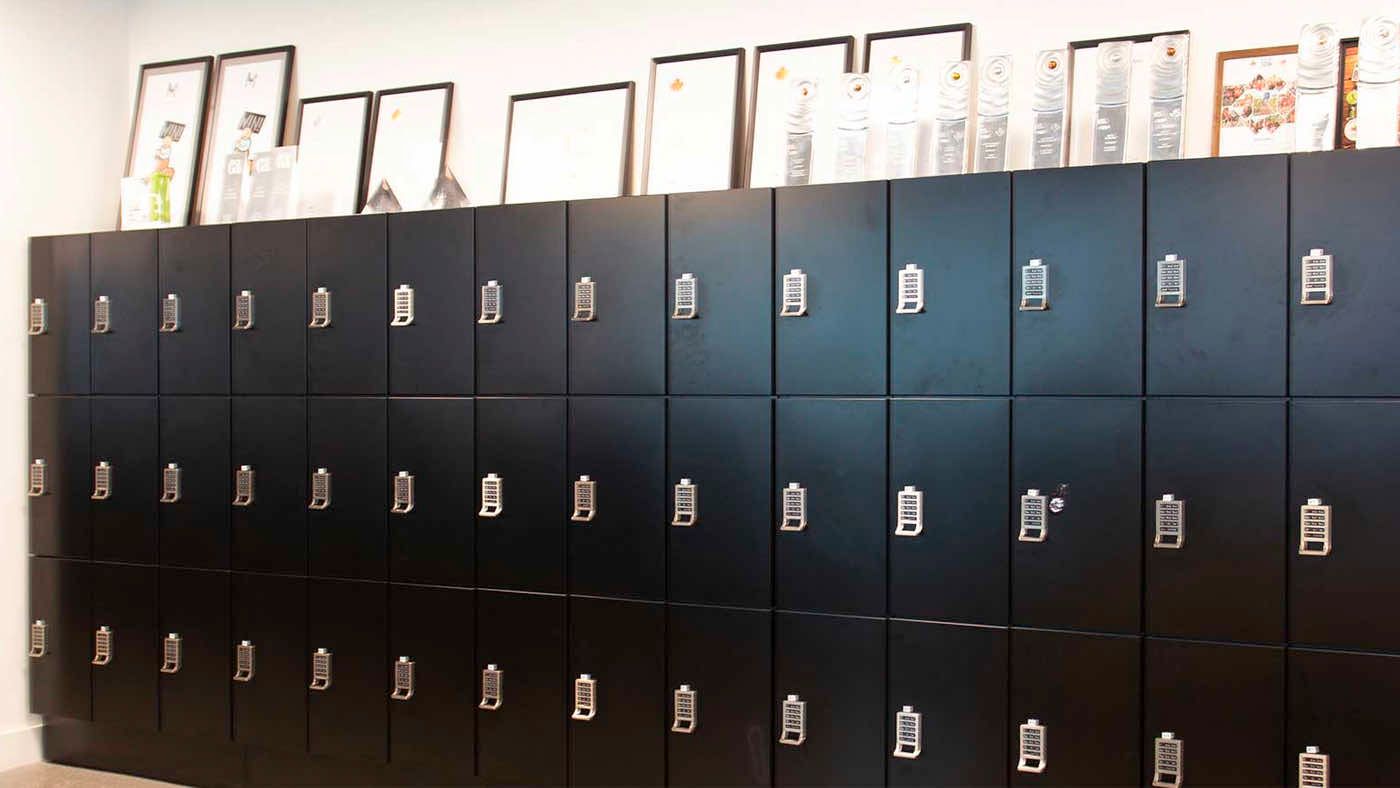 wall of black day use lockers in a creative firm environment
