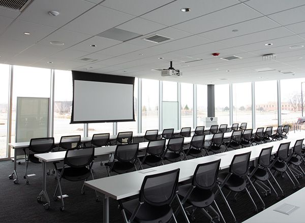 police department presentation room with large screen at the front of the room and tables and chairs