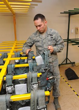 soldier showing how Spacesaver's parachute storage system works