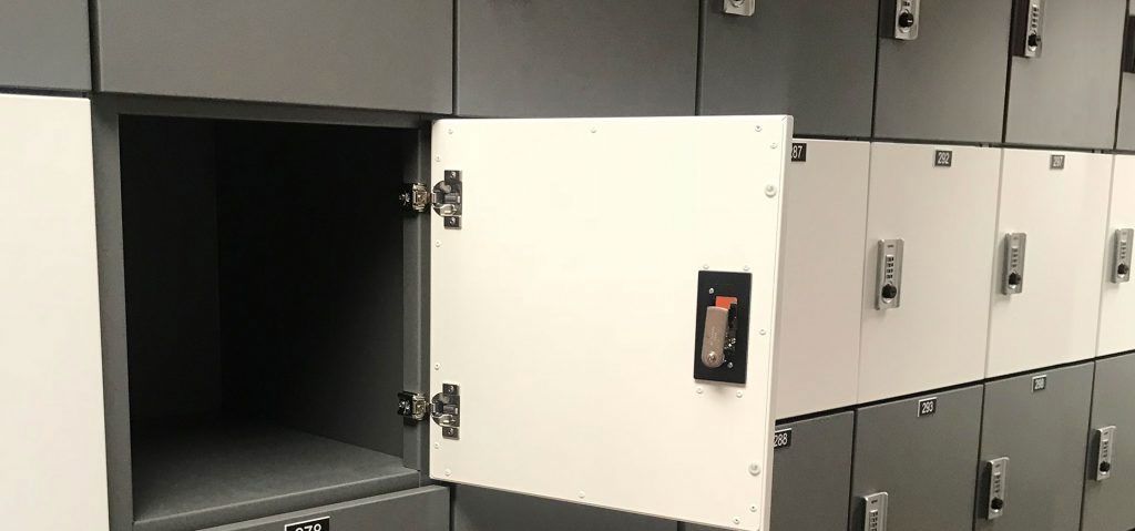 Open locker in a office locker wall with combination locks