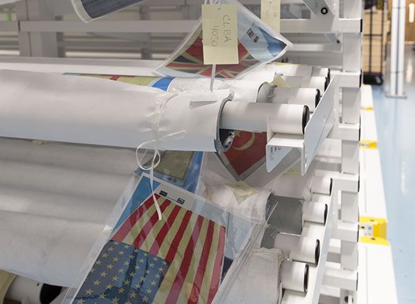historic flag collection stored on rolled textile racks