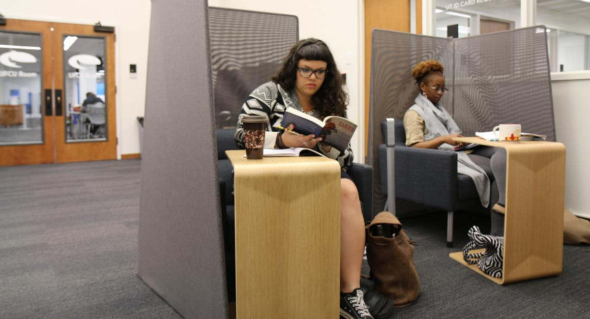 Two women reading in a scholars commons space