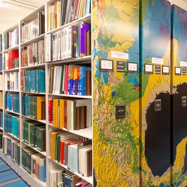 school library with Spacesaver mobile shelving system and custom painted end panel graphics