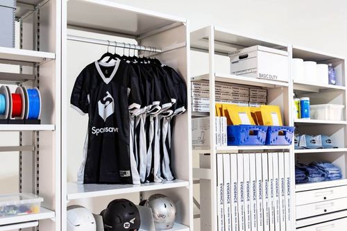 4-Post FreeSpan holding a variety of items including jerseys, helmets, banker boxes, and bins